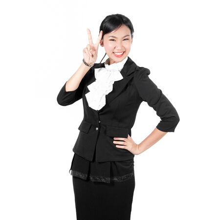 Young business woman showing victory sign with two fingersの写真素材