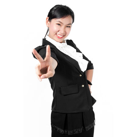 Young business woman showing victory sign with two fingersの写真素材