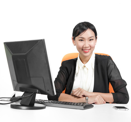 Young pretty business woman using computer on deskの写真素材