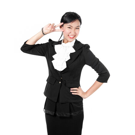 Young business woman showing victory sign with two fingersの写真素材