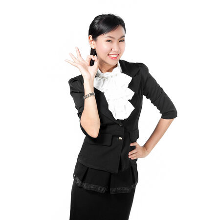 Young business woman showing okay signの写真素材
