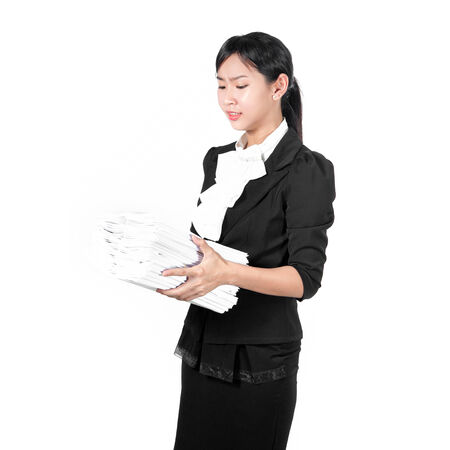 Young pretty business woman holding pile of document unhappyの写真素材