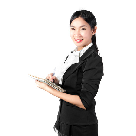 Young pretty business woman holding book and pencilの写真素材