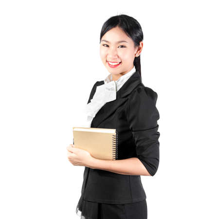 Young pretty business woman holding bookの写真素材