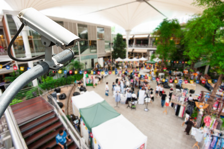 CCTV camera or surveillance operating with crowded people in background