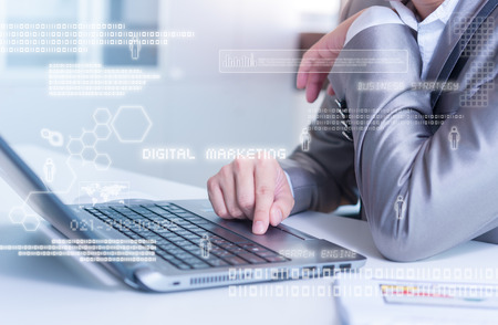 Close up of business man typing on laptop conputer with technology layer effectの写真素材