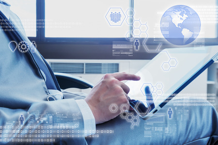 Business man using tablet with digital layer effectの写真素材