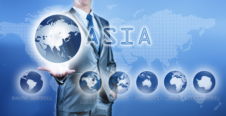 Businessman choosing asia continent on virtual digital screen, business concept of decision makingの写真素材