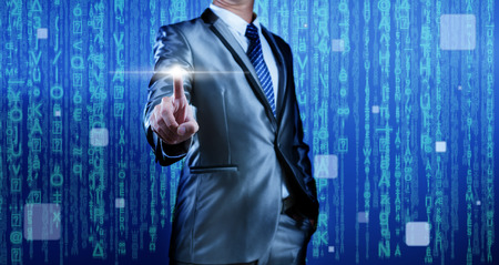 Business man with digital background pressing on blank button editableの写真素材