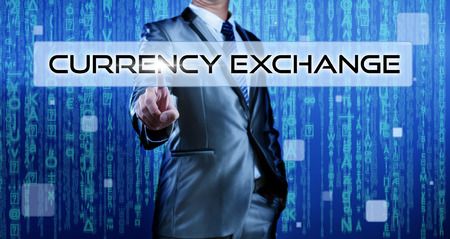 Business man with digital background pressing on button currency exchangeの写真素材