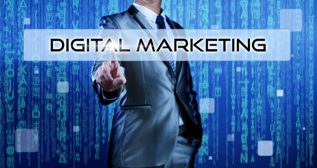 Business man with digital background pressing on button digital marketingの写真素材