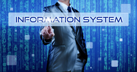 Business man with digital background pressing on button information systemの写真素材