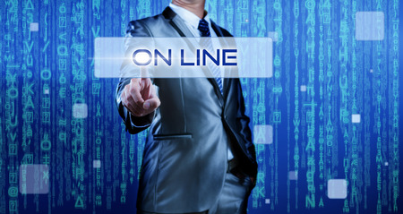 Business man with digital background pressing on button on lineの写真素材