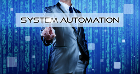 Business man with digital background pressing on button system automationの写真素材