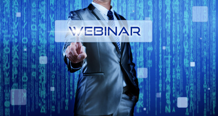 Business man with digital background pressing on button webinarの写真素材