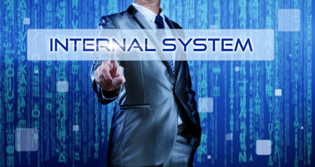 Business man with digital background pressing on button internal systemの写真素材