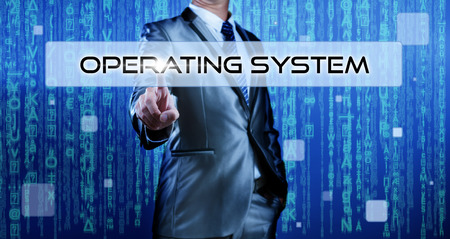 Business man with digital background pressing on button operating systemの写真素材