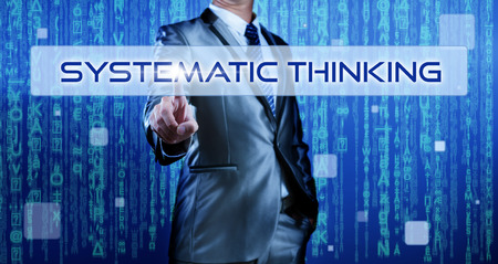 Business man with digital background pressing on button systematic thinkingの写真素材