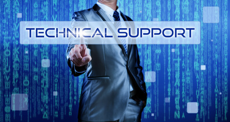 Business man with digital background pressing on button technical supportの写真素材