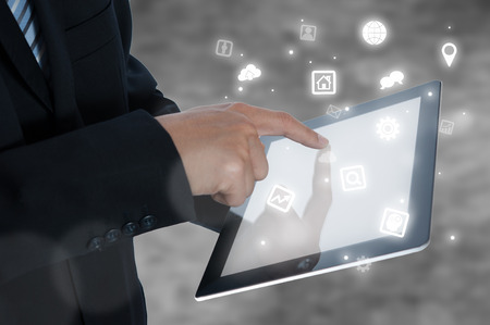 businessman holding tablet showing icon, business strategy conceptの写真素材