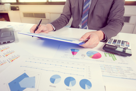 Businessman show analyzing report, business performance conceptの写真素材