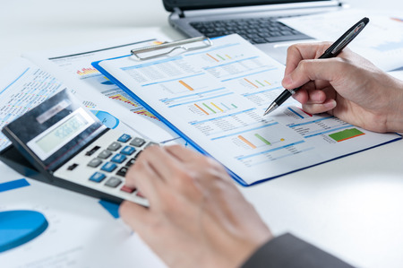 Businessman using calculator analyze reportの写真素材