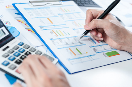 Businessman using calculator analyze reportの写真素材
