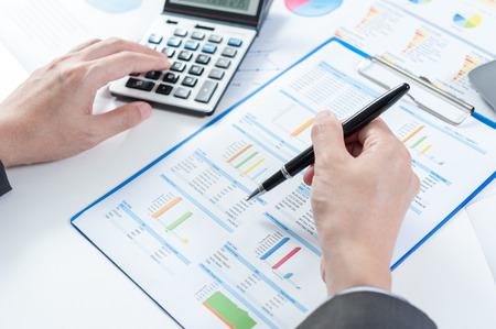 Businessman using calculator analyze reportの写真素材