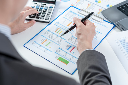 Businessman using calculator analyze reportの写真素材