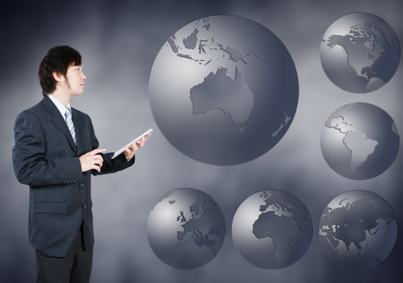 Asian Businessman choosing Australia continent, business concept of decision makingの写真素材
