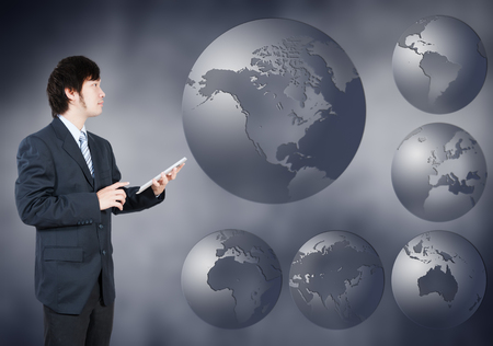 Asian Businessman choosing North america continent, business concept of decision makingの写真素材