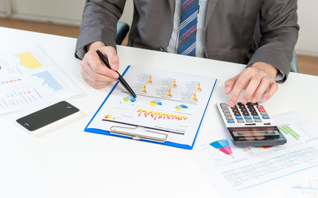 Businessman analyzing report, business performance conceptの写真素材