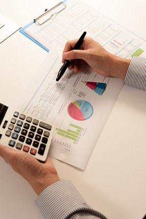 Businessman analyzing report, business performance conceptの写真素材