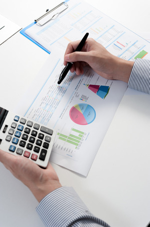 Businessman analyzing report, business performance conceptの写真素材
