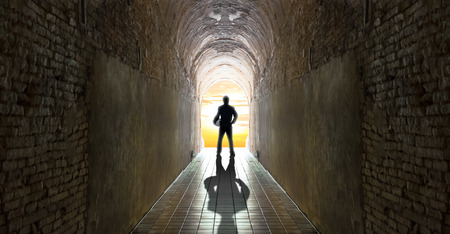 Businessman standing at tunnel, business strategy conceptの写真素材