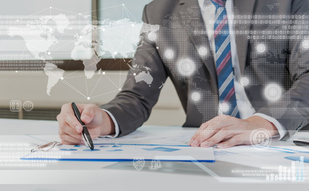 Business person working on computer against technology backgroundの写真素材