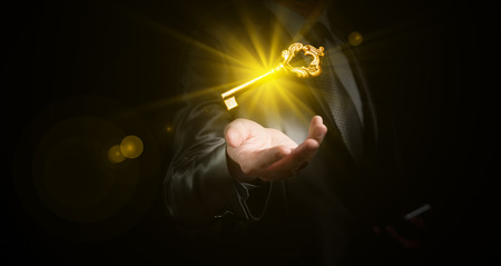 businessman hold a gold shining key, business conceptの写真素材