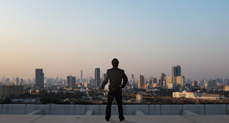 businessman stand on roof top of skyscrabber, business conceptの写真素材