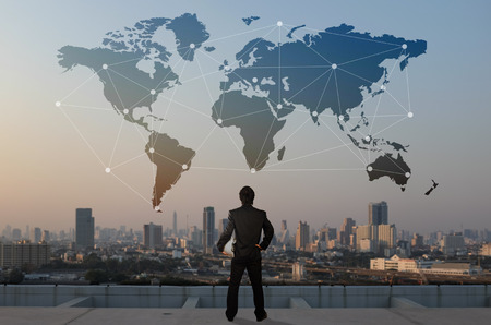 businessman stand on roof top of skyscrabber, business globalization concept
