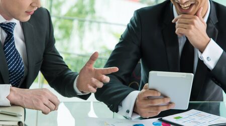 Two businessman using tablet in meetingの写真素材