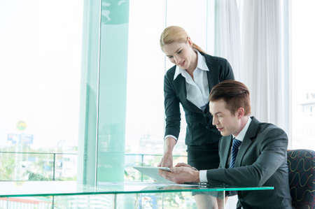 businessman and woman discussing in officeの写真素材