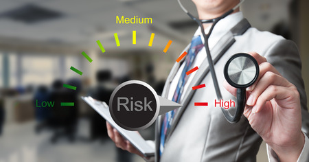 Business man with stethoscope with risk management concept Business man with stethoscope with risk management concept
