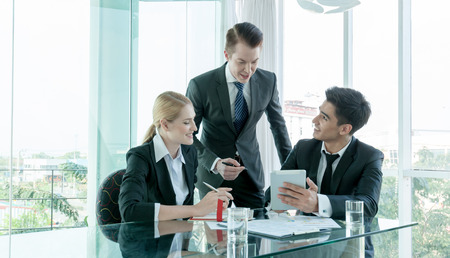 business partners discussing documents and ideas at meetingの写真素材