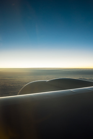 Clouds and sky as seen through window of an aircraftの写真素材
