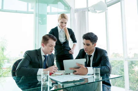business partners discussing documents and ideas at meetingの写真素材