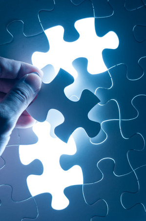 Hand insert jigsaw, conceptual image of business strategy, decision making conceptの写真素材
