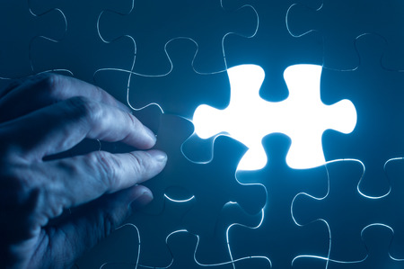 Hand insert jigsaw, conceptual image of business strategyの写真素材