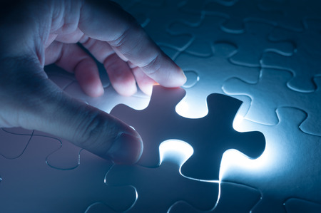 Hand insert jigsaw, conceptual image of business strategyの写真素材