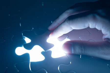 Hand insert jigsaw, conceptual image of business strategyの写真素材