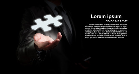 Businessman hold jigsaw piece with space for text editing, business strategy conceptの写真素材